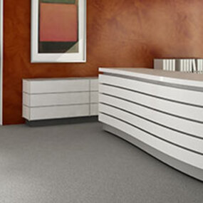 Modernes Empfangsbüro mit geschwungener weißer Theke und stilvoller Büroeinrichtung.